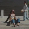 Video of a woman walking at the city wearing the iconic Slim in black
