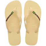 light yellow flip flops with yellow straps that say havaianas in brown, and a brazil flag, top view
