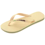 light yellow flip flops with yellow straps that say havaianas in brown, and a brazil flag, front left view