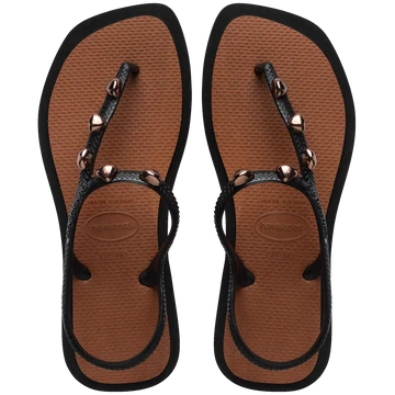 Top view of sandal with brown back straps, silver studs, and light brown sole